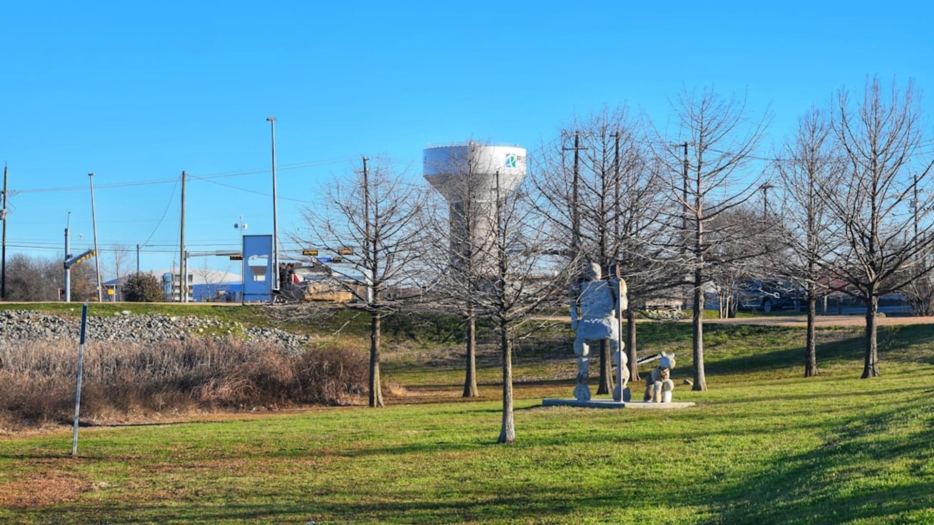 View of Pflugerville - Diverse Community with Small-Town Heart Lake Pflugerville park with walking trails, families enjoying outdoor recreation, suburban community feel